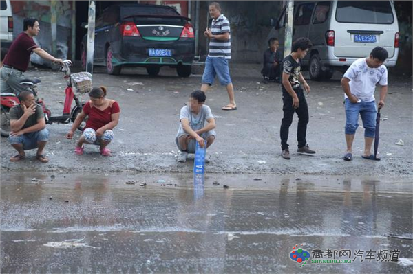 组图：郑州村民积水里捞车牌 一个牌要百元